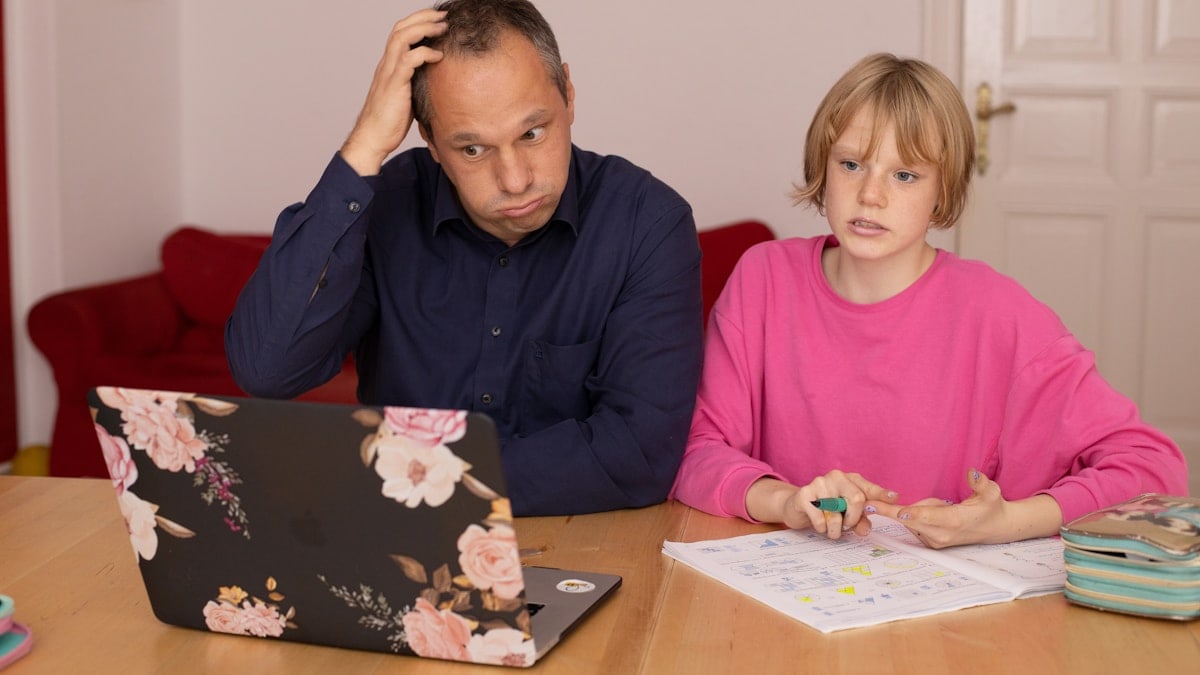 Perplexed father during homeschooling with his daughter.